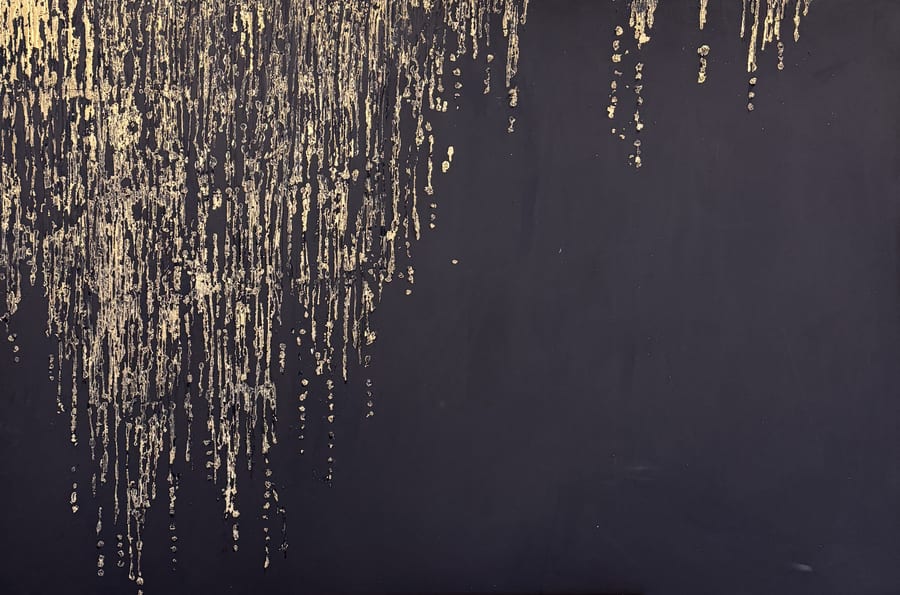 A deep black canvas with streams of gold foil drifting down from the top edge.